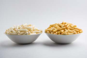 Kaju Katli is a Diamond shape Indian sweet made using cashew sugar and mava, served in a plate or bowl over moody background. selective focus