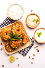 Ragda Pattice is a popular Street food or chat made of potato Patties. served in a steel plate, bowl or ceramic plate with tamarind and cilantro chutney