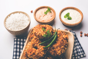 Ragda Pattice is a popular Street food or chat made of potato Patties. served in a steel plate, bowl or ceramic plate with tamarind and cilantro chutney