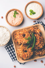 Sabudana vada or Sago fried cake served with peanut chutney over moody background, popular fasting recipe from India. 