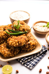 Ragda Pattice is a popular Street food or chat made of potato Patties. served in a steel plate, bowl or ceramic plate with tamarind and cilantro chutney