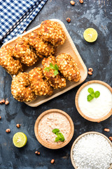 Sabudana vada or Sago fried cake served with peanut chutney over moody background, popular fasting recipe from India. 