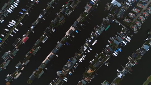 Aerial view of recreational harbour for small boats and bungalows on the lake at Loosdrecht Kalverstraat, the Netherlands.