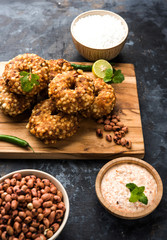 Sabudana vada or Sago fried cake served with peanut chutney over moody background, popular fasting recipe from India. 