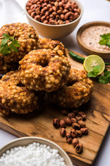 Sabudana vada or Sago fried cake served with peanut chutney over moody background, popular fasting recipe from India. 