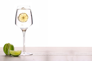 cocktail with lime and ice isolated on wood table