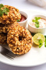 Paneer Butter Masala also known as Panir  makhani or makhanwala. served in a ceramic or terracotta bowl with fresh cream and coriander. Isolated over colourful moody background. selective focus