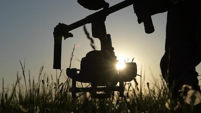 Men with Video Camera Stabilization Device. Videography Equipment. Slow Motion Footage