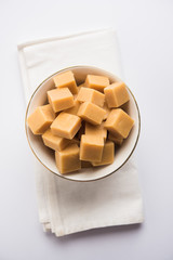 Barley water in glass bottle with raw and cooked pearl barley wheat/seeds. selective focus