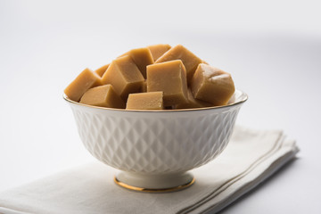 Barley water in glass bottle with raw and cooked pearl barley wheat/seeds. selective focus