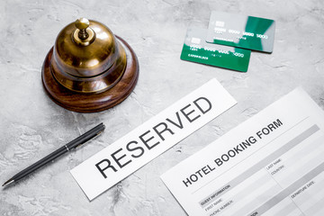 reservation form on hotel reception stone desk background