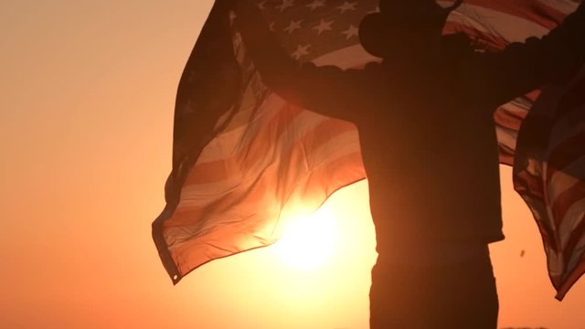 Western Wear Caucasian Men with United States Flag in Hands. Scenic Sunset. Slow Motion Footage