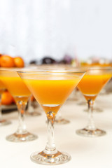 Orange Juice Cocktail on a white table in martini glasses in the party
