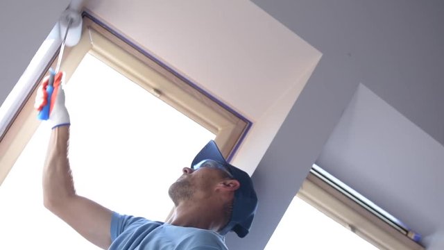 Caucasian Construction Worker with Paint Brush Painting Apartment Room. Slow Motion Footage