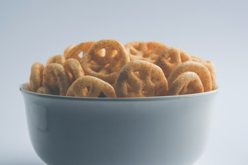 Kaju Katli is a Diamond shape Indian sweet made using cashew sugar and mava, served in a plate or bowl over moody background. selective focus