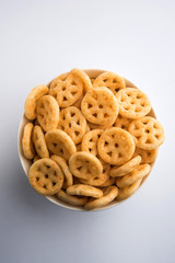 Kaju Katli is a Diamond shape Indian sweet made using cashew sugar and mava, served in a plate or bowl over moody background. selective focus