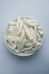 Kaju Katli is a Diamond shape Indian sweet made using cashew sugar and mava, served in a plate or bowl over moody background. selective focus