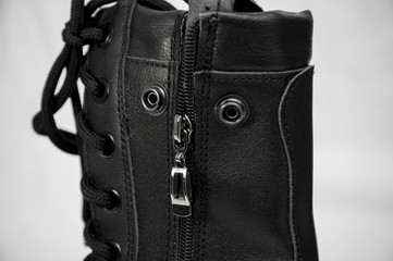 military boots black on the lock and with rivets, sole with a pattern, legs for protection of legs