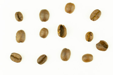 close up of medium or dark roasted coffee beans isolated on white background, can be used as a background or graphic object in your ads.