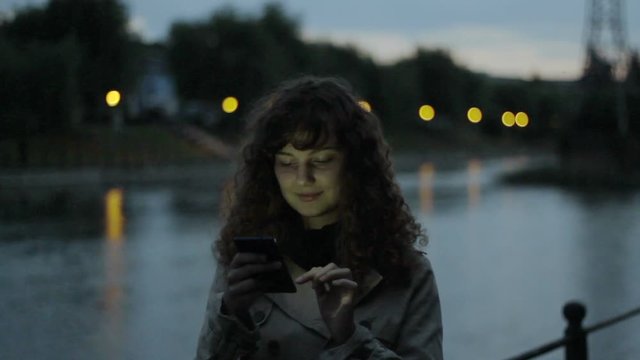 Lonely Young Woman Using her Smartphone