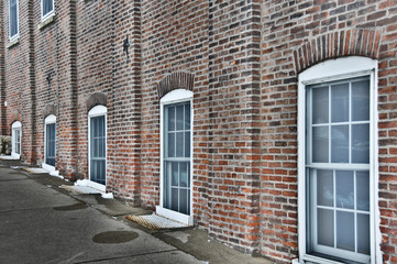 white windows and a red brick wall