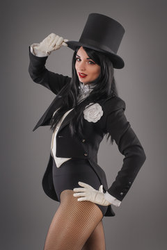 Woman magician in costume suit doing magic imagination performance