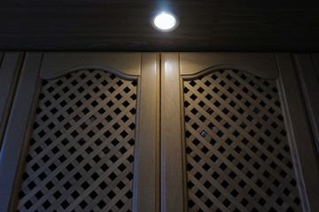 bulb in the kitchen with a latticed  wooden door