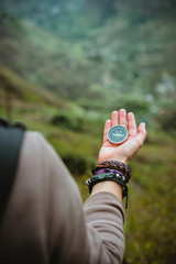 Compass in womens palm. Female explorer the mountainous terrain on Santo Antao Island. Cape Verde....