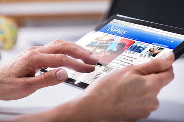 Close-up Of A Person's Hand Using Digital Tablet