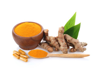 Turmeric , turmeric powder in wooden cup with wooden spoon and turmeric capsules on white background.