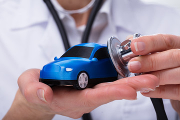 Doctor's Hand Examining Car