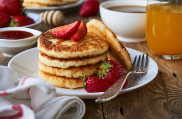 Cottage cheese pancakes with strawberry on a plate