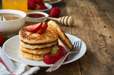 Cottage cheese pancakes with strawberry on a plate