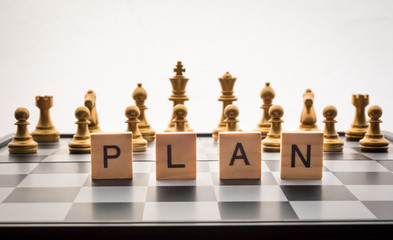 Chess board and the words "plan" - Business planning concepts.