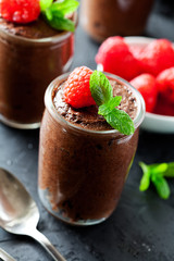 Glass of homemade dark chocolate mousse with raspberries