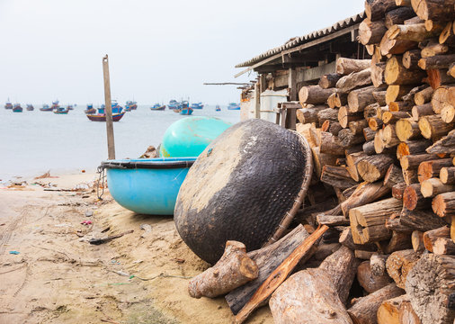 Traditional vietnamese basket boats on the shore at the bay of Mui Ne fishing town in south Vietnam.