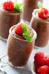 Pots Of Homemade Chocolate Mousse With Raspberries