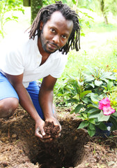 A Gardner planting a flower