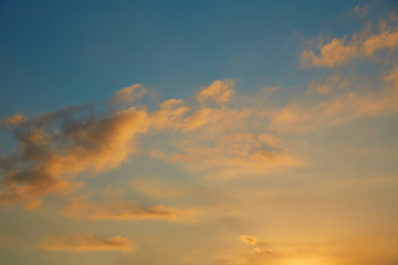 Naklejka na ściany i meble Sunset sky orange clouds on blue sky