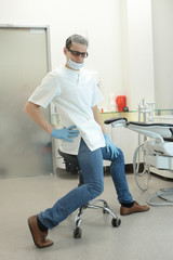 Male dentist exercising in his office waiting for patient
