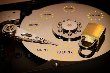concept of data protectionsecurity. open hard disk drive with closed padlock over.