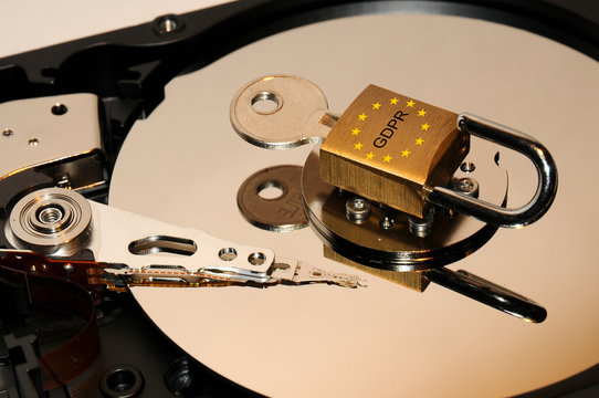 concept of data protection security. open hard disk drive with padlock and key over.