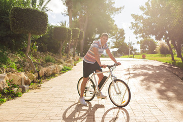 Young fit man during a bike ride on a sunny day.