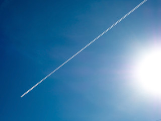 long contrail cloud of smoke from jet engine