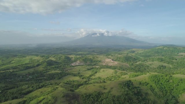 Aerial view of mountain valley with hillscovered forest, trees, mount Iriga. Luzon, Philippines. Slopes of mountains with evergreen vegetation. Mountainous tropical landscape.