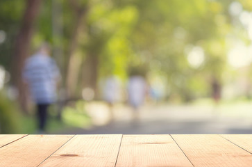 wooden table and walking at park blurry background