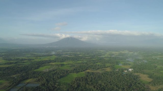 Aerial view of mountain valley with hillscovered forest, trees, Mount Iriga. Luzon, Philippines. Slopes of mountains with evergreen vegetation. Mountainous tropical landscape.