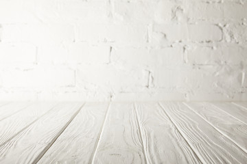 white wooden tabletop and white wall with bricks