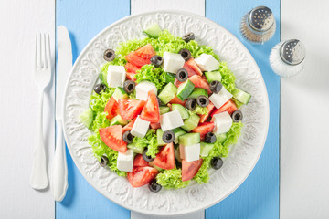 Tasty Greek salad with cherry tomatoes, lettuce and feta cheese