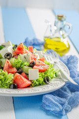 Tasty Greek salad with black olives, feta cheese and lettuce